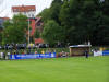 Blick auf die Gegengerade, links G�stebank mit Trainer